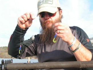 Jay Stone shows the bottom two 1/16-ounce jigs and 2-ounce bell weight of a kitchen sink rig.