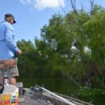 Tommy Tregle uses 10-foot crappie poles with fly reels mounted on them. Note the bait bucket with the bubble-up aerator used to hold his grass shrimp alive.