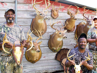 From left, William, Lionel and Jenni Washington show off some of the family’s recent Louisiana whitetail trophies.