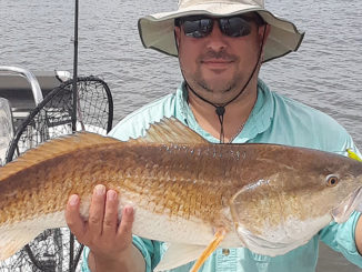 Scott Baker of Arkansas shows off a nice red caught with Smokin’ Reels Charters out of Lydia.