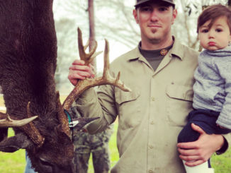 Dillon Savoy and his 16-month-old son Ryder pose with the big buck he shot on Jan. 17 at the White Castle Hunting Club in Iberville Parish.