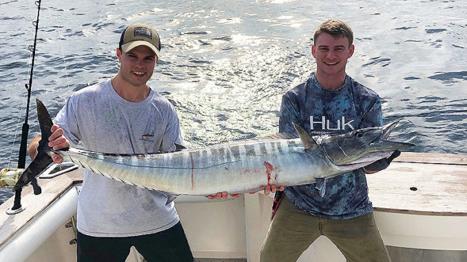 Tyler Hatrel, right, and Keaton Biggs pose with a nice wahoo they reeled in earlier this year while trolling shaky baits south of Fourchon.