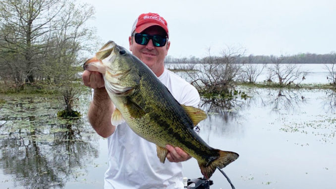 Brett Trouille, of Maurice, shows off the 10.03-pound largemouth he caught March 30 in the 12-15 area. The big bass, which was bedded down, bit a white Texas-rigged Zoom Craw.