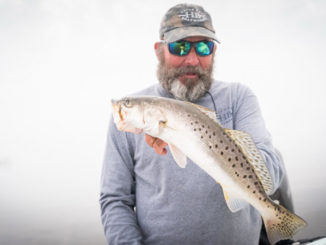 Jeff Poe on a foggy day with a nice speckled trout.