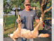 The grandson of homeowner Roland Collins, Tyler Bruce, shows the coyote that his grandfather killed inside his home.
