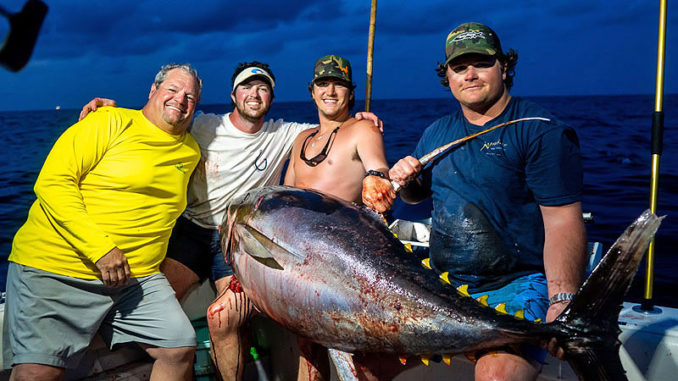 Mike McElroy III (far right) was on the rod when the crew of the Hook N Bull (from left, Mike McElroy II, Ryeley Jacobs and Luke Myers) landed a 236.6-pound yellowfin tuna out of Pass Christian, Miss., that appears to be a Mississippi state record. (Photo by John Michael Gory)