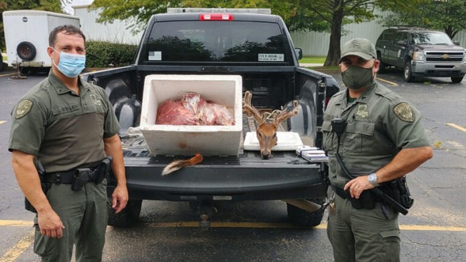 Agents with seized deer that was taken at night and out of season.
