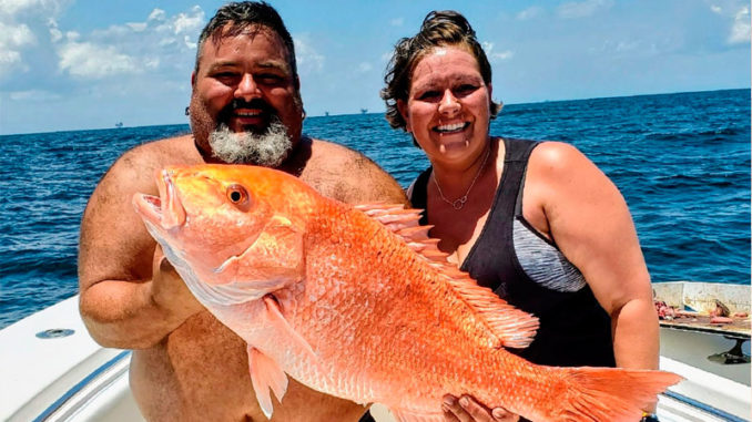 Chuk Cole and Jessica Spooner with Jessica’s 22.4-pound snapper caught out of Venice on July 18, 2020.