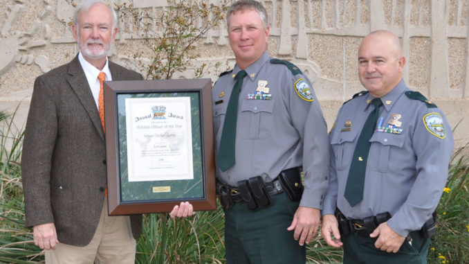 Shikar-Safari Club Representative Lea Perez presents the 2019 Shikar-Safari Club International 2019 Conservation Officer of the Year award to Sgt. Michael Garrity (Capt. Bryan Marie right). (Photo courtesy LDWF)