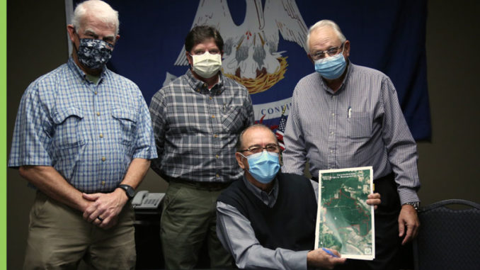 LDWF Secretary Jack Montoucet (seated) with (standing, left to right) John Rik Thistlethwaite, Lawrence Thistlethwaite and Dr. Patrick Thistlethwaite.