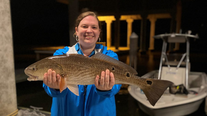 Participant shows off her catch after learning new skills at 2020 Women's Fishing Workshop