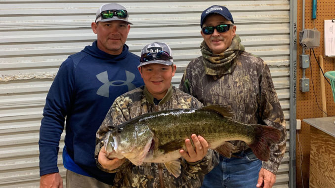 Ollie Pruett Slaughter (right) of Prairieville caught this 11.82-pound bass at Toledo Bend on May 2.