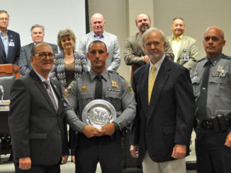 LDWF Secretary Jack Montoucet with Corporal James Bruce, the Shikar-Safari Club Representative, and Col. Chad Hebert with Louisiana Wildlife and Fisheries Commission representatives in the back.