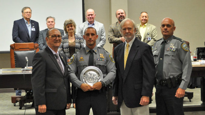 LDWF Secretary Jack Montoucet with Corporal James Bruce, the Shikar-Safari Club Representative, and Col. Chad Hebert with Louisiana Wildlife and Fisheries Commission representatives in the back.