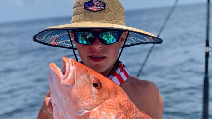 Ethan Defelice with a red snapper that he caught while fishing the SMI blocks with his uncle, Brett Adams.