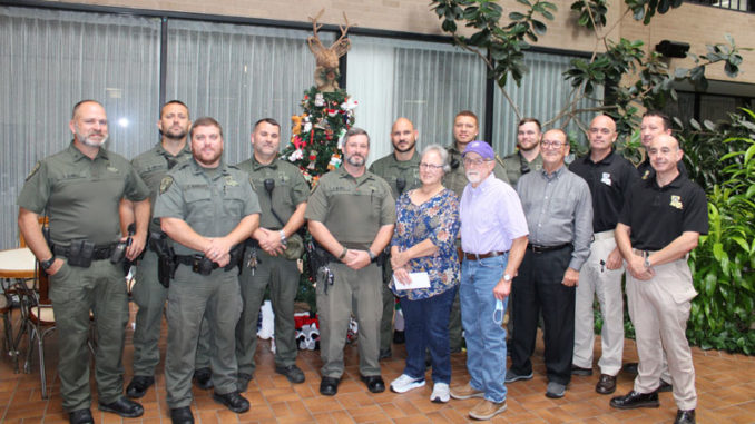Left to right: Sgt. Channing Duvall, Corporal Brandon Fontenot, Sgt. Allan Marbury, Corporal Jason Sanchez, Corporal Jason Marks, Senior Agent Adam Tieben, Patricial Melancon, Senior Agent Nelson Kennerson, Ronald Melancon, Agent Garrett Kirkland, Sec. Jack Montoucet, Col. Chad Hebert, Lt. Col. Travis Huvall and Major Eddie Skena. (Photo courtesy LDWF)