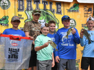 These youngsters, shown with their catch of bass, are among thousands who have enjoyed this annual event over the years.