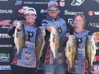 Alexis Virgilitto, left, and Tayor Bacot, right, get help from their boat captain, Alexis' father, Bradley Virgillito, holding their five bass weighing 30 pounds, 3 ounces. The "hawgs" caught by the Parkway High School Fishing Team topped a 109-angler field fishing The Bass Federation High School State Championship at Caddo Lake on March 13.