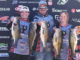 Alexis Virgilitto, left, and Tayor Bacot, right, get help from their boat captain, Alexis' father, Bradley Virgillito, holding their five bass weighing 30 pounds, 3 ounces. The "hawgs" caught by the Parkway High School Fishing Team topped a 109-angler field fishing The Bass Federation High School State Championship at Caddo Lake on March 13.