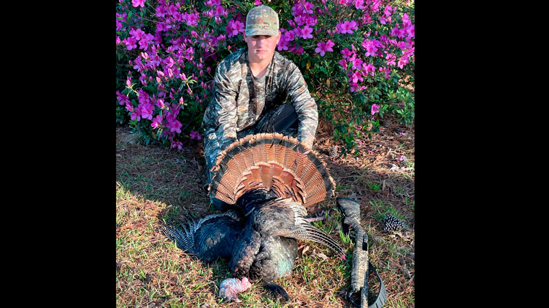 Braxton Hill with the gobbler he killed while hunting with his dad, Ray Hill, and grandfather, Bruce Dodd, in West Feliciana Parish on March 27, 2022.