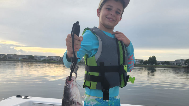 Drew Fallo holds up a catfish.