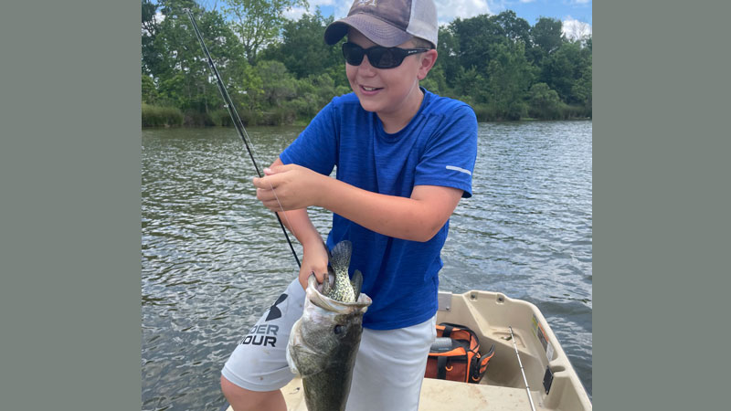 Brecken Figueiredo, 12, of Ville Platte caught this big bass with a sac-a-lait in its mouth on a 20-acre private lake.