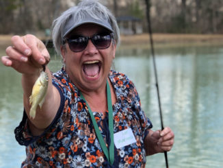 Participant Lori Marinovich poses with her catch from fishing practice during a Women’s Fishing 101 Workshop. (Photo courtesy LDWF)
