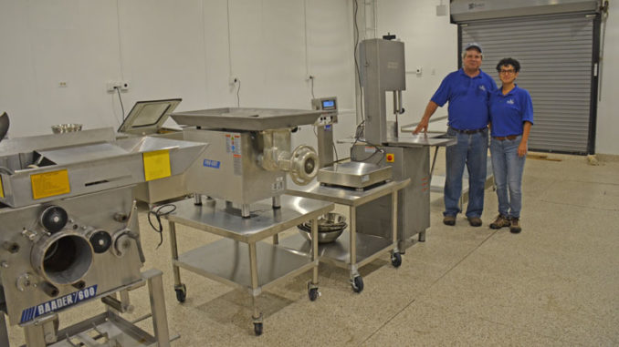 Thomas Hymel and Evelyn Watts of the LSU AgCenter and Sea Grant, stand next to equipment in the Seafood Processing Demonstration Lab in Jeanerette. (Photo courtesy of LSU AgCenter)