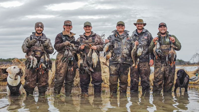 (Left to right) Waylon (white lab), Jake Hale, Samuel Costello, Elijah Ward, Chasten Costello, Maclendon Sharp, Hunter Johnson and Sage (black lab).