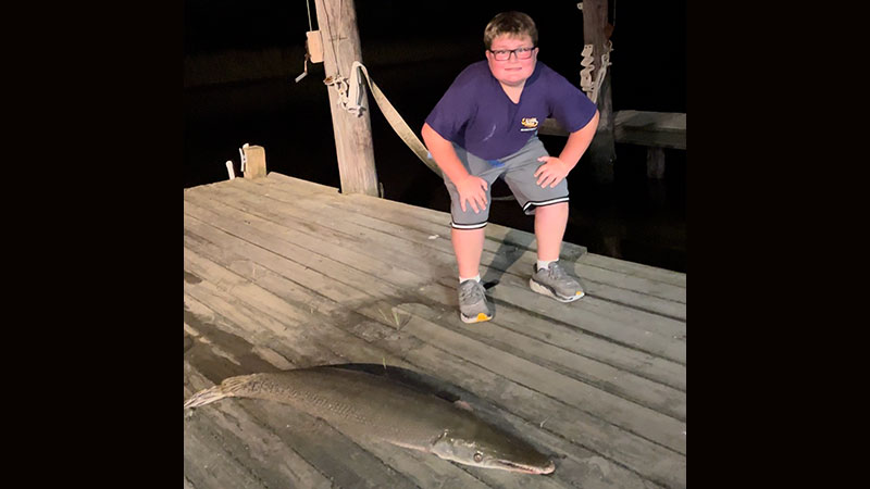DJ Stilley, 11, from Albany with a gar fish caught at Camp Noona Wastoo in Dulac.