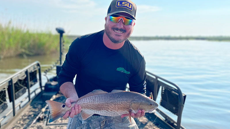 Scott Gibson with a nice redfish caught with an H&H Gold Spoon on May 23, 2023 in the Rigolets near the L&N train bridge.