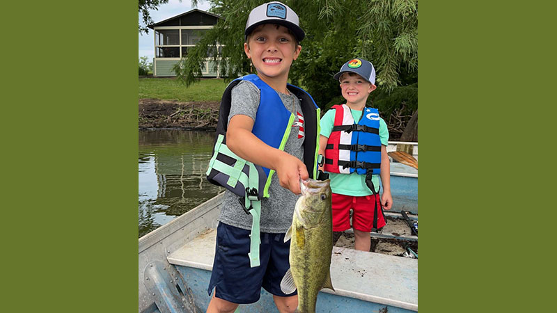 Six-year-old Mack Lensing with his first bass caught on a Zebco 6-foot Splash spincast and a Texas rigged Zoom Junebug.