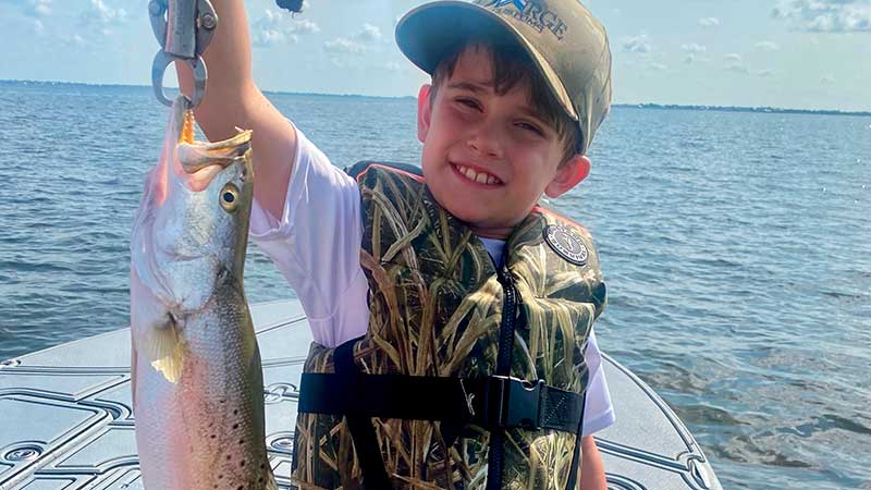 Finn Davidson, 7, with a beautiful speckled trout caught on Big Lake during a Memorial Day trip.