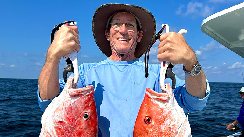 Dr. Kurt O'Brien with two hammer red snapper caught out of Port Foruchon.