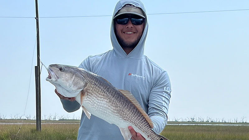 Tyler Autin with a pretty red caught on June 11 in Port Sulphur on a black and chartreuse swim jig in marsh cuts.