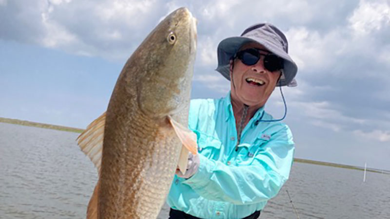 Bob Breck with a big redfish (30+ inches) caught fishing out of Shell Beach in early June.