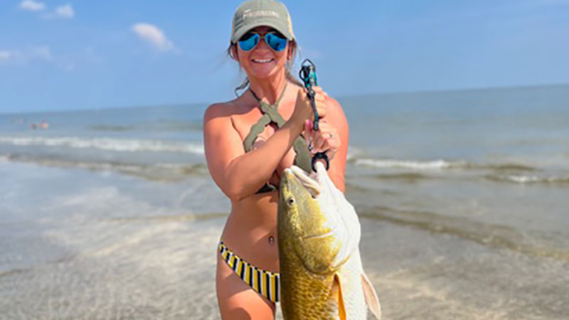 Abby Bellon of SWLA with a big bull red caught on a big chunk of cut mullet over Memorial Day Weekend 2023.