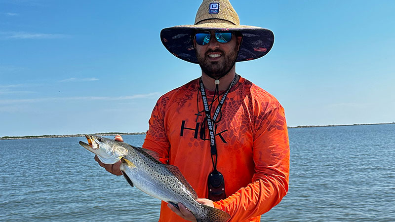 Laine Primeaux with a trout caught at the long rocks by Seven Dollar Bay.